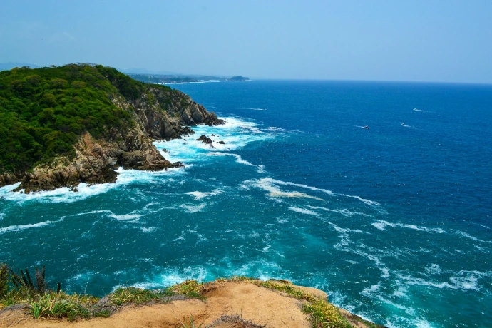 A view of the ocean from the top of a hill